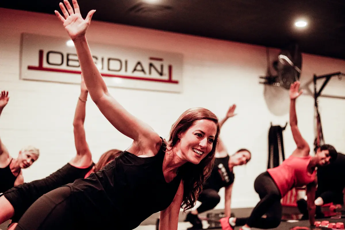 Obsidian® BURN class working through a side plank series